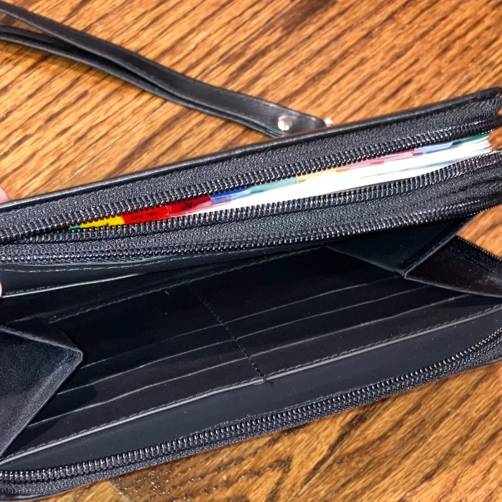 Black planner/organizer with zippered closure, wallet slot, addresses, goals